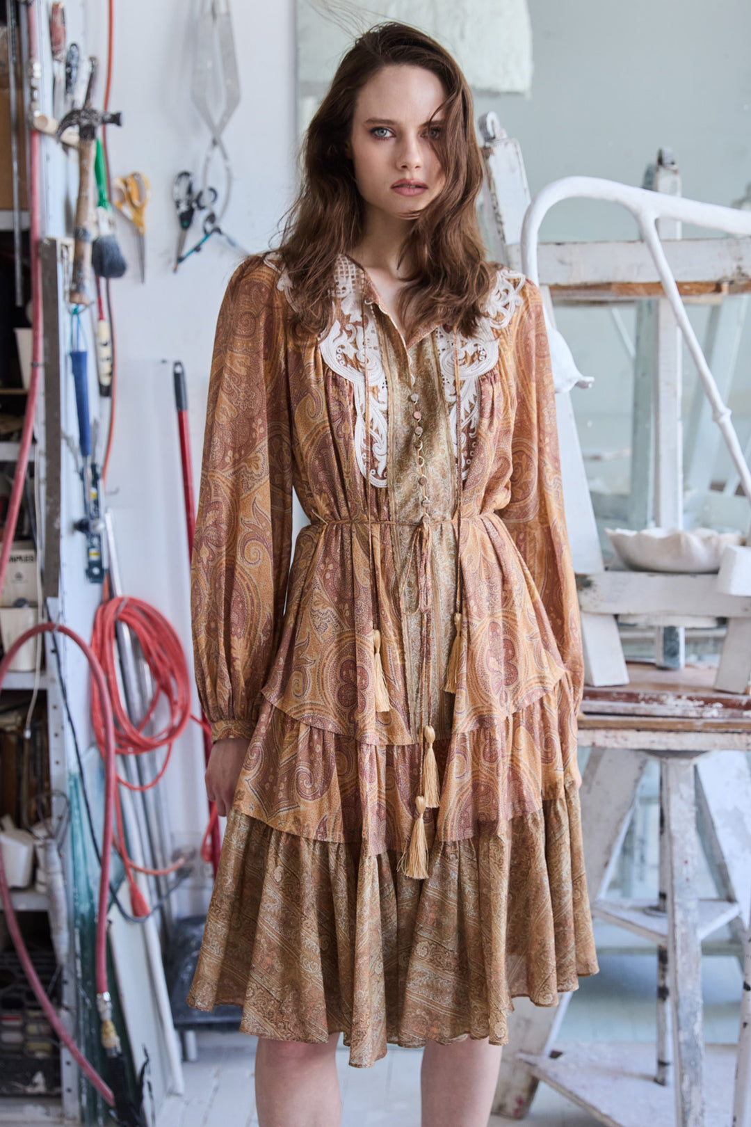 Gray printed dress with relaxed silhouette, long sleeves, and soft drape; front view on model.