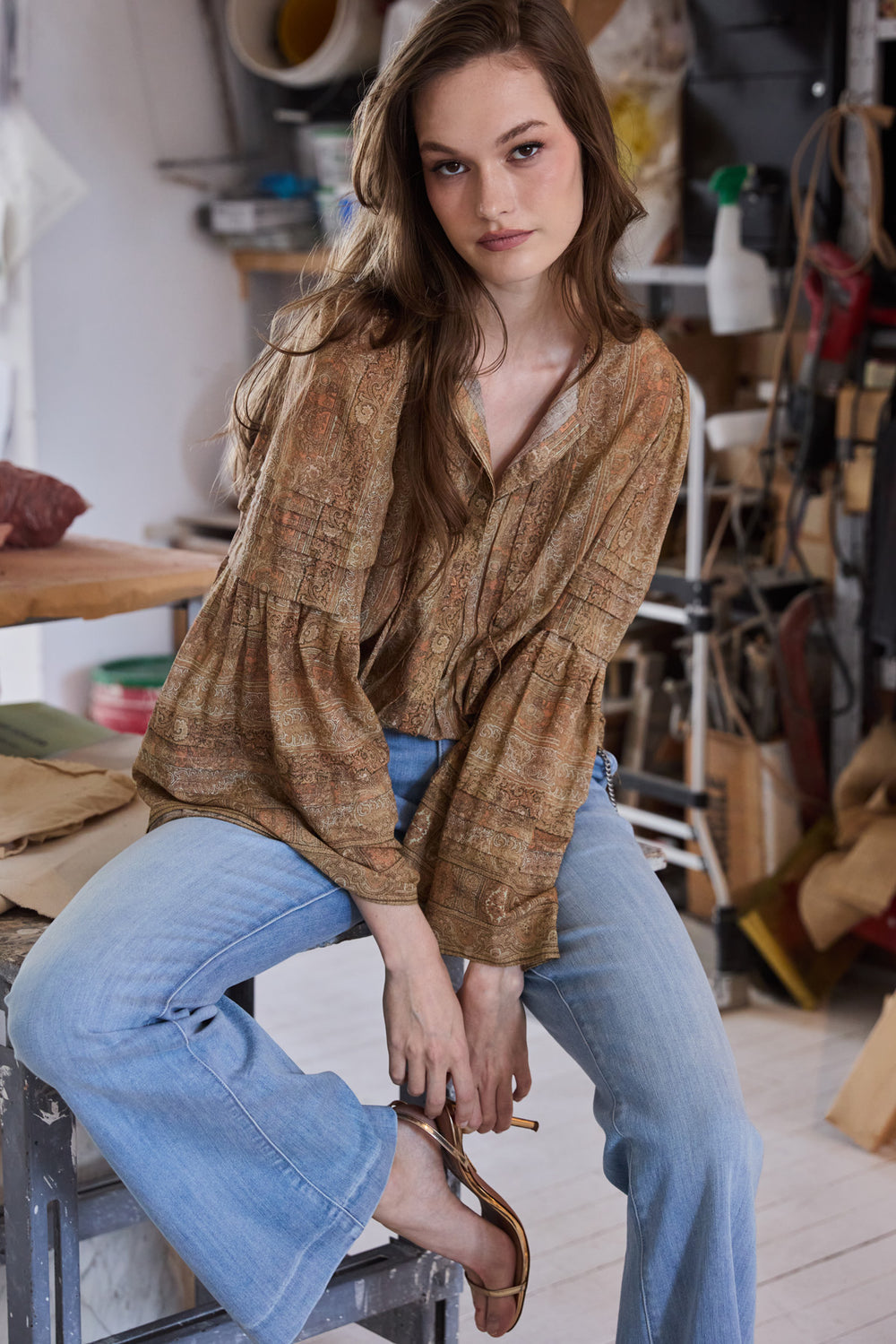 Relaxed-fit blouse with pintucked bodice, button front, and blouson sleeves; front view on model.