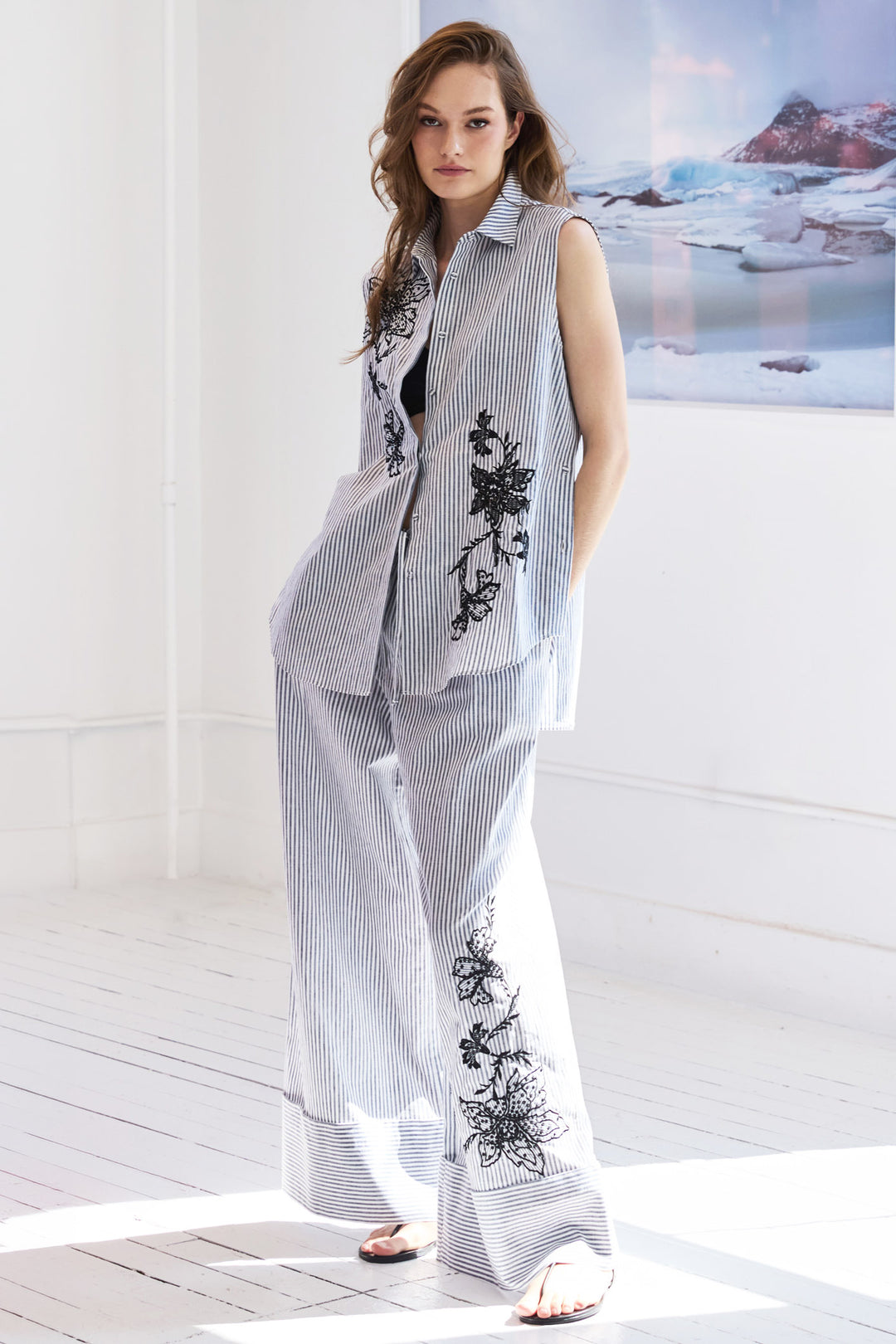 Sleeveless shirt with straight silhouette, striped cotton, embellished details at yoke; front view on model.