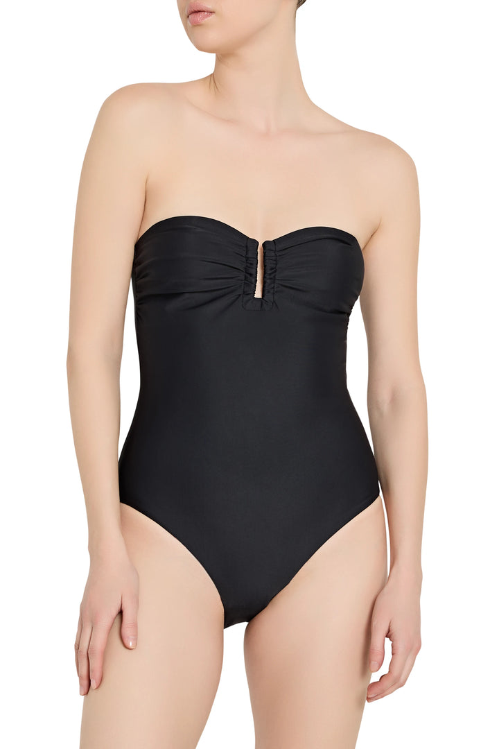 Black strapless swimsuit worn by a model on a white background