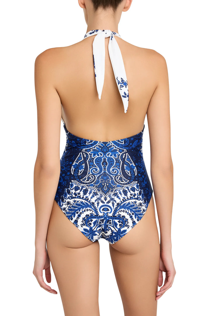 Halter one-piece swimsuit with open back, fitted at waist, allover paisley print fabric; back view on model.