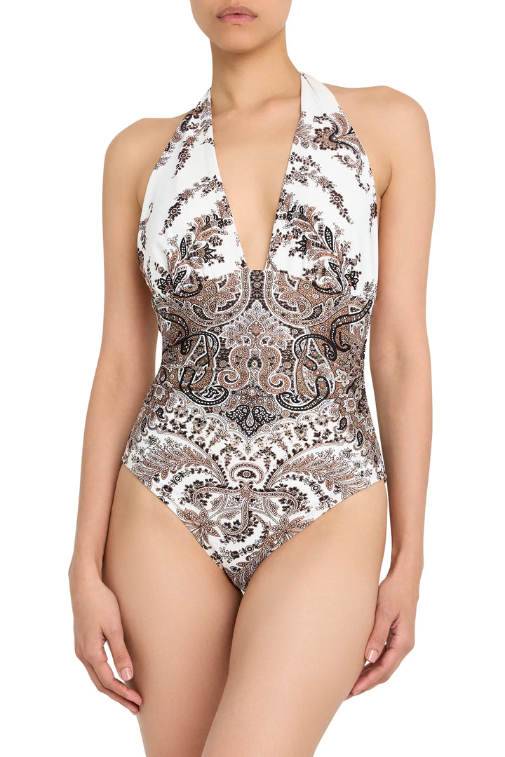 Halter one-piece swimsuit with deep plunge neckline, ruched bodice, paisley print; front view on model.