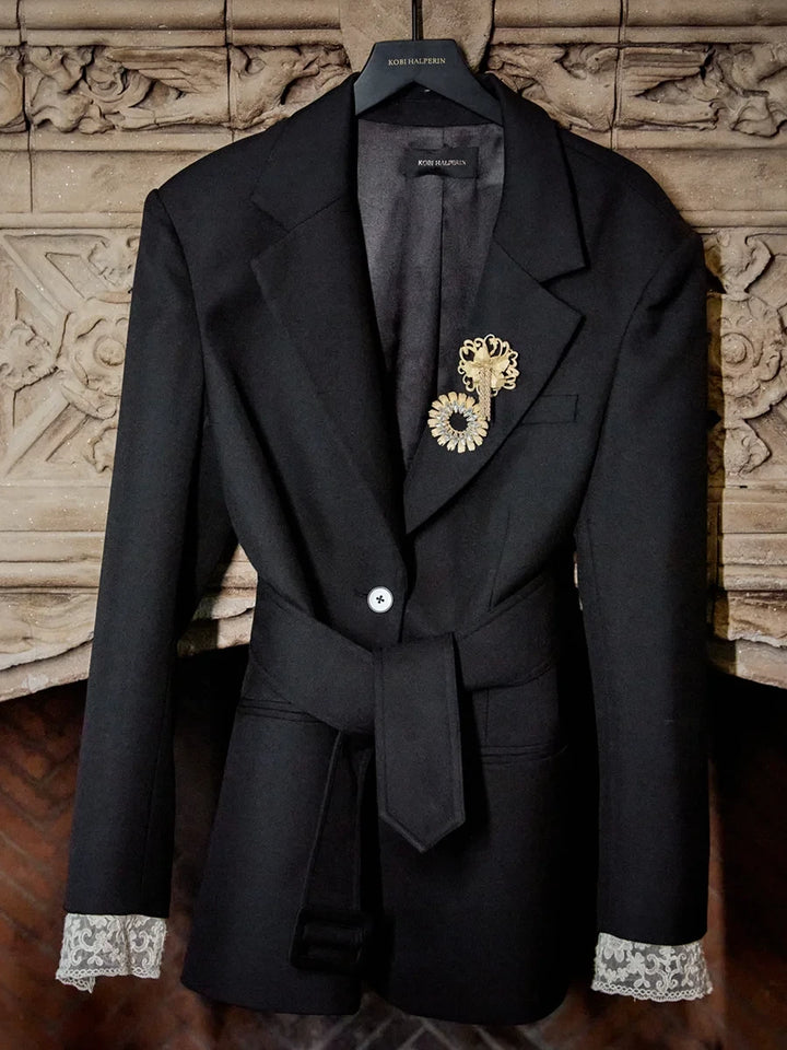 Jillian Jeweled Belted Blazer in tropical wool, belted waist, jeweled brooch, and removable lace cuffs, front view.