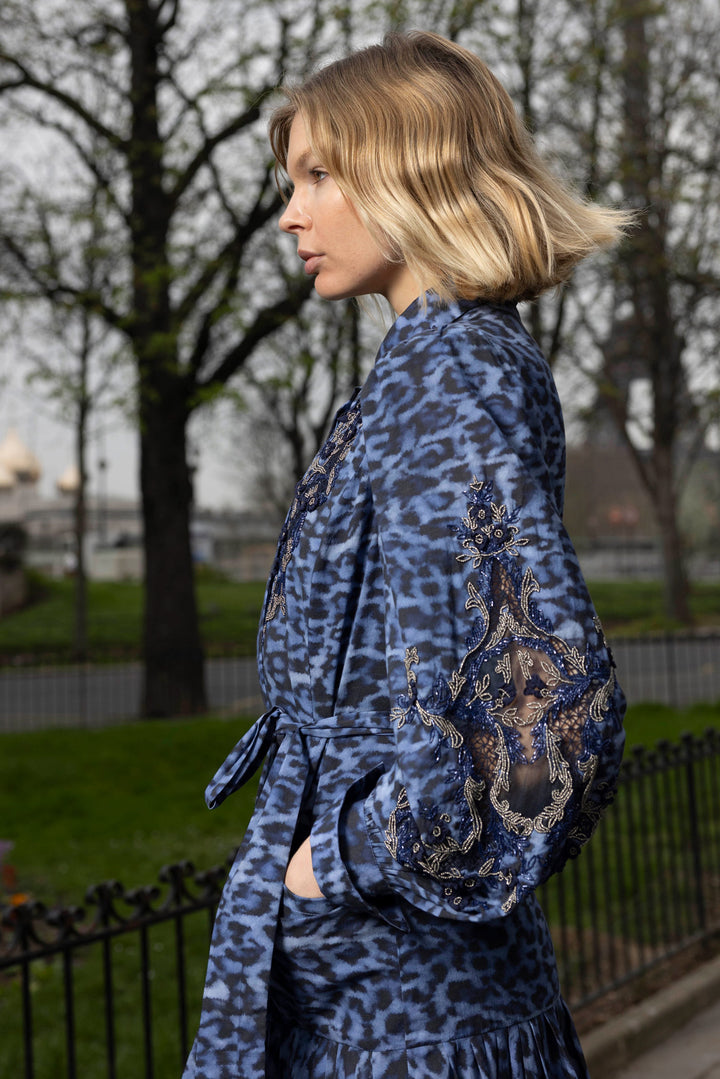 Midi silhouette dress with draped construction and patterned fabric; front view on model.