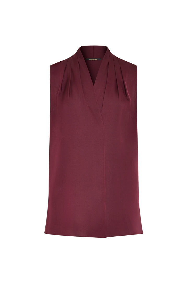 Sleeveless silk blouse with V-neck, subtle pleats at front, fluid drape. Front view on white.