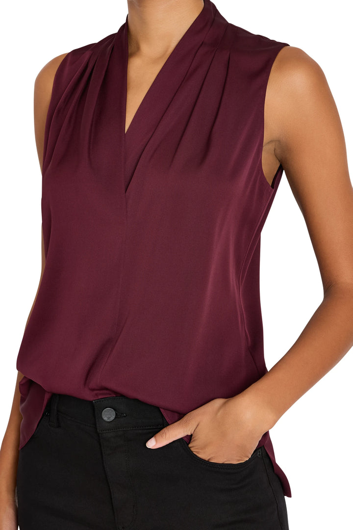 Sleeveless silk blouse with relaxed fit, scoop neckline, clean lines. Front view on model.