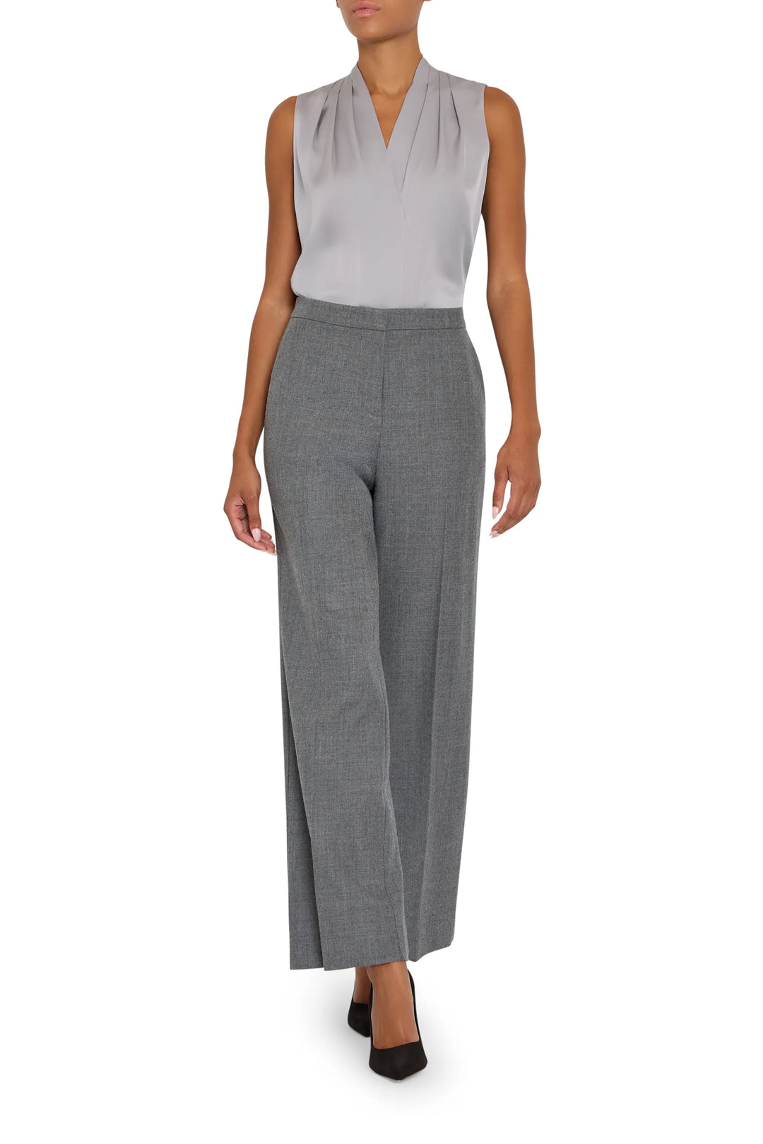 Silk blouse with relaxed silhouette, draped construction, and subtle sheen; front view on model.