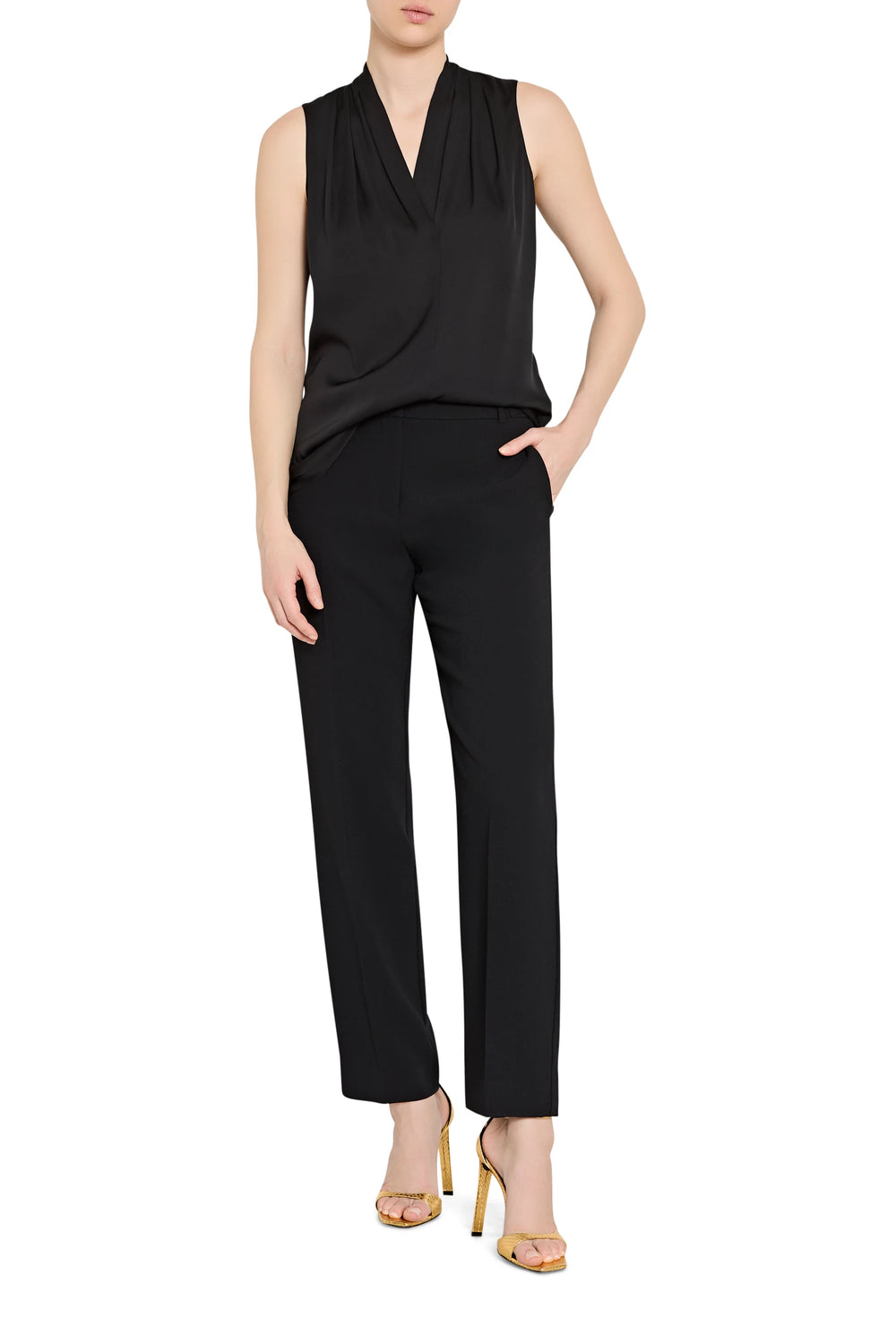 Black sleeveless top and pants worn by a model on a white background