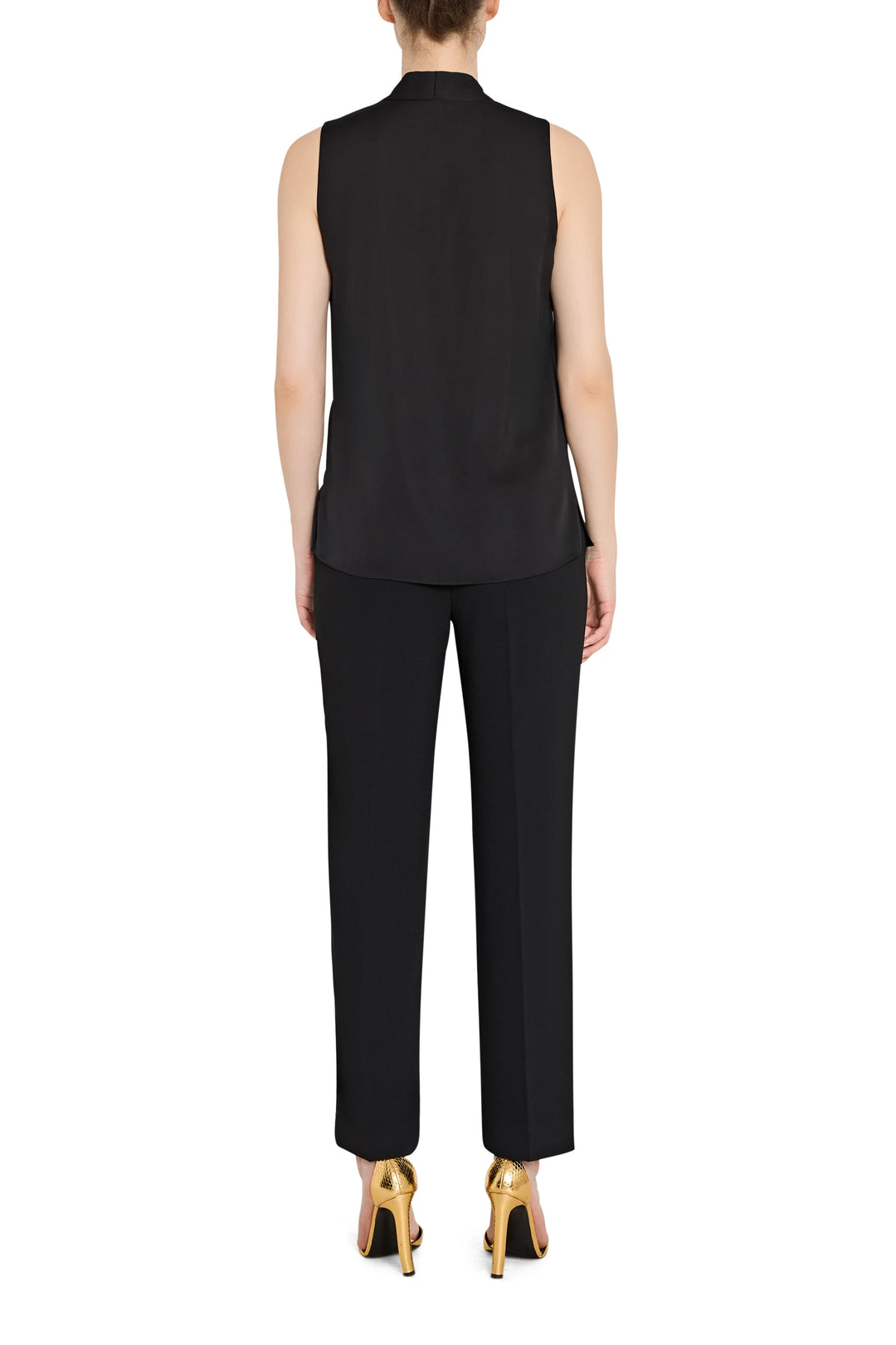Person wearing a black sleeveless top and pants on a white background