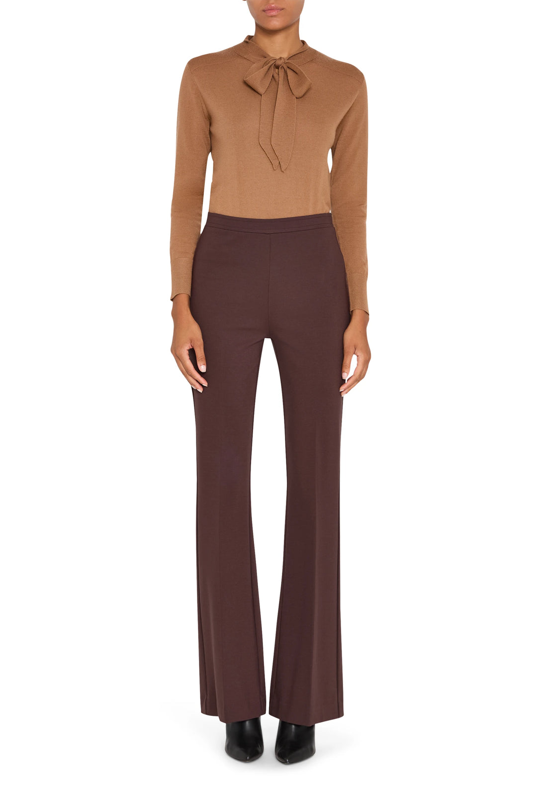 Wide-leg silhouette, full-length, tailored waistband, pressed creases in soft woven fabric; front view on model.