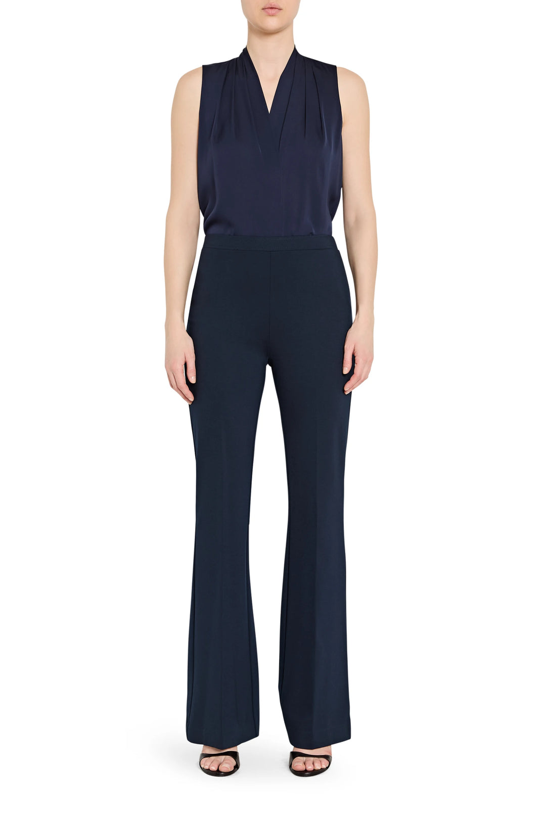Fluid silhouette pant with clean waistband and tailored seams, full-length. Front view on model.