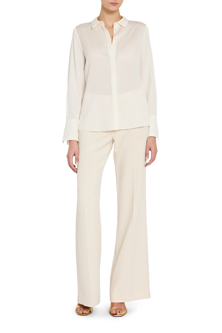 Woman wearing a white shirt and pants on a white background