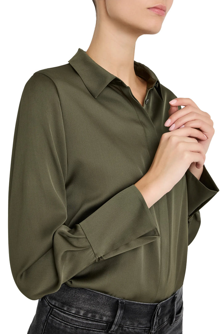 Fluid silk blouse with soft drape, classic collar, relaxed fit, button front placket; front view on model.