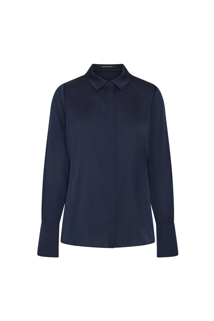 Fluid silk blouse with classic collar, wide cuffs, and clean lines. Shown in front view on white background.