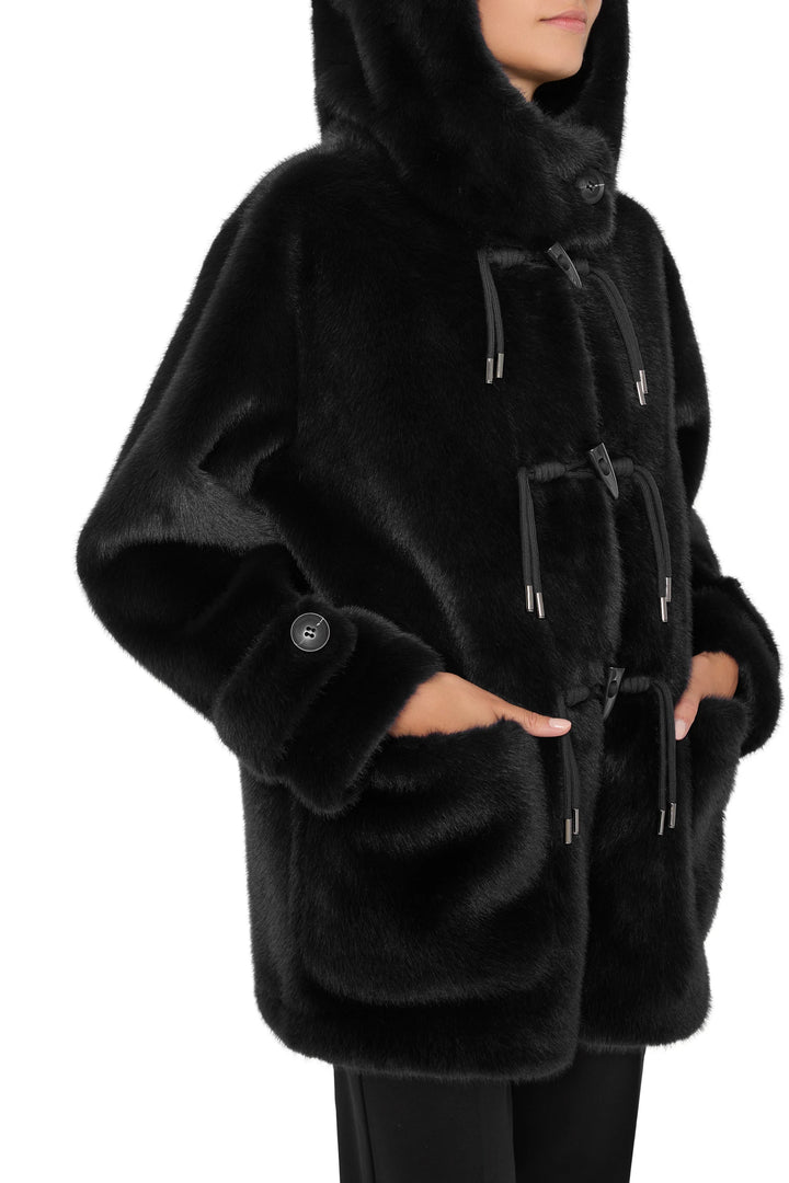 Black faux fur coat with hood, toggle closures, front pockets, relaxed silhouette; front view on model.