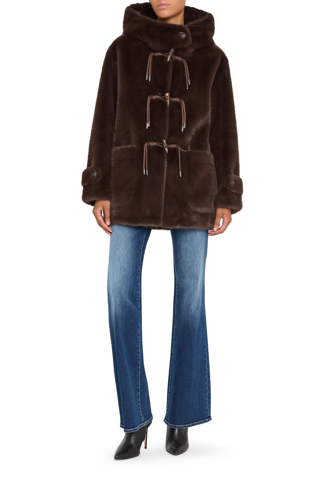 Faux fur coat with relaxed silhouette, plush texture, concealed front closure; front view on model.