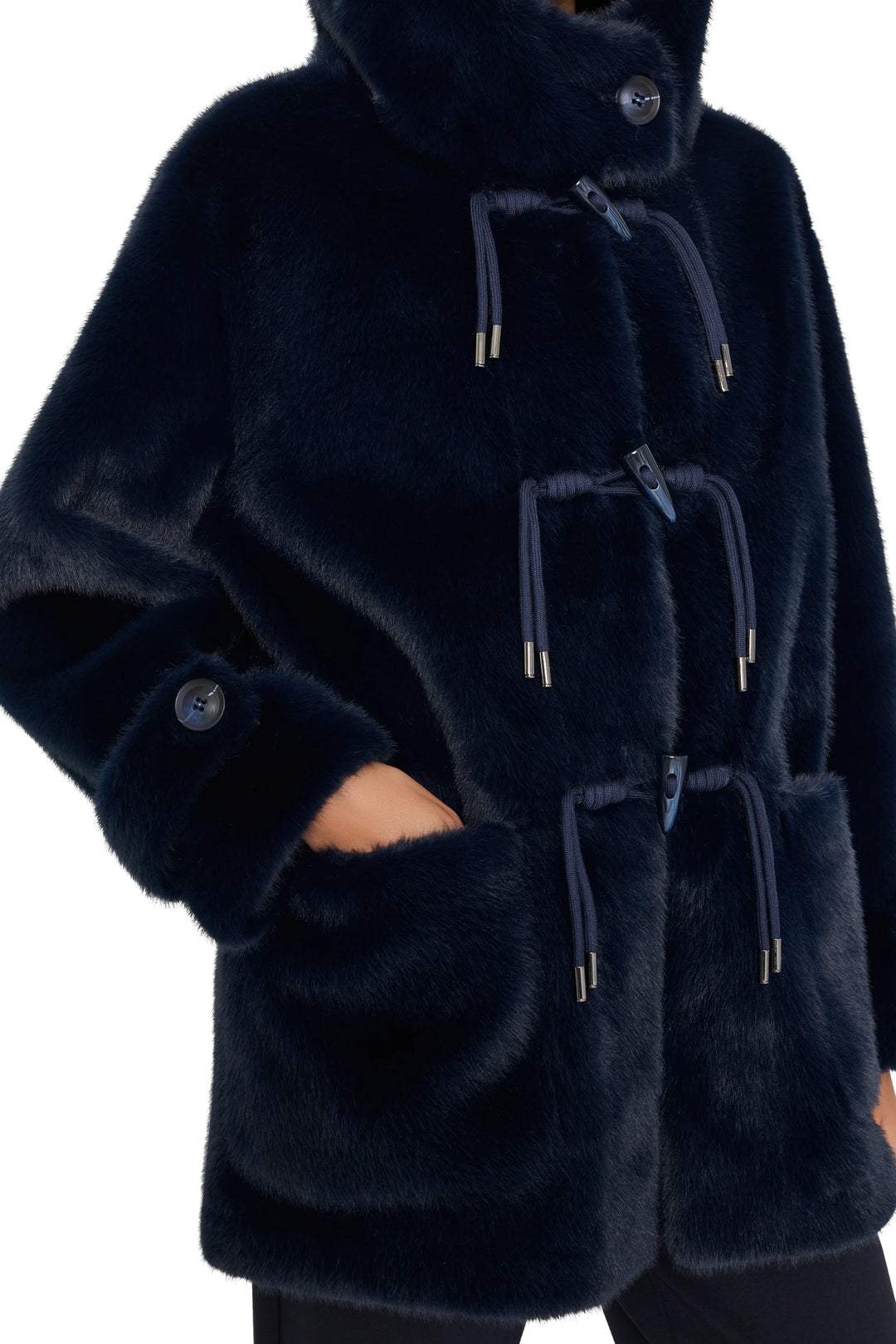 Dark blue faux fur coat with drawstrings, large front pockets; straight silhouette, plush texture; front view on model.