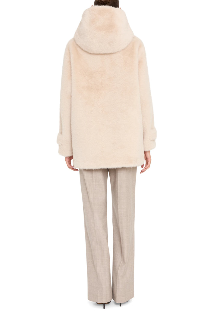 Faux fur coat with relaxed, straight silhouette and long sleeves. Back view on model.