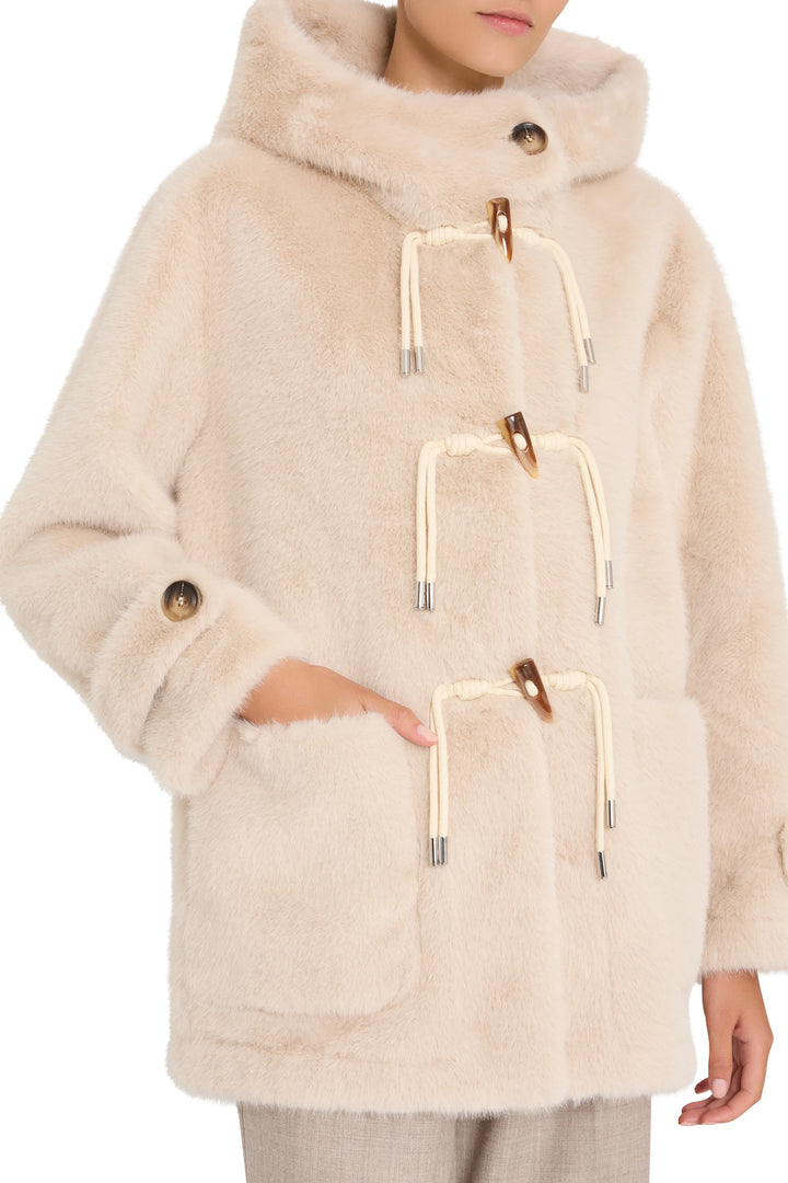 Faux fur coat with toggle closures, front pockets, relaxed fit silhouette; front view on model.