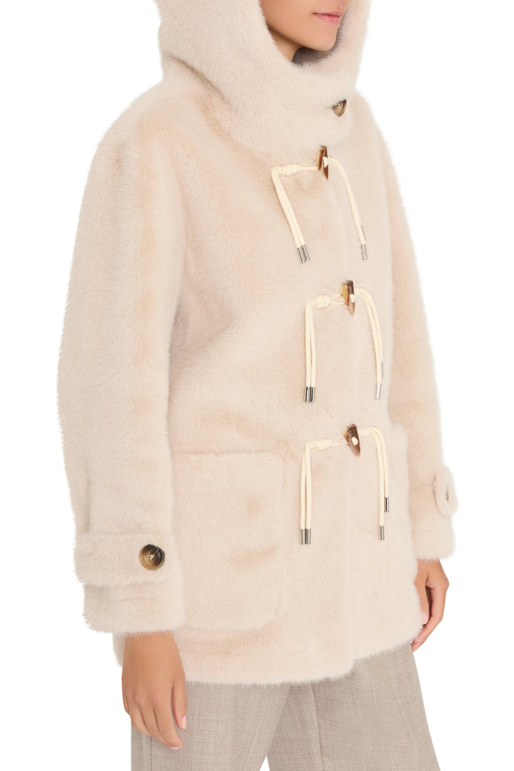Faux fur coat with relaxed silhouette, toggle ties, patch pockets. Front view on model.
