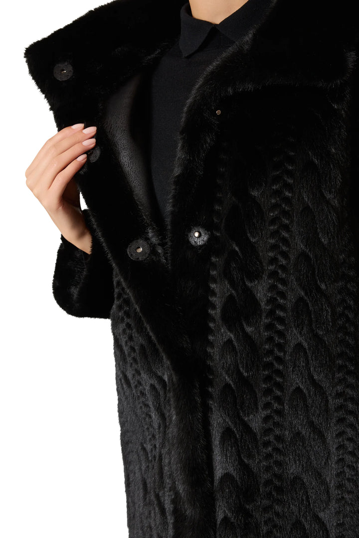 Longline faux fur coat with cable-inspired texture, large buttons, relaxed silhouette. Front view on model.