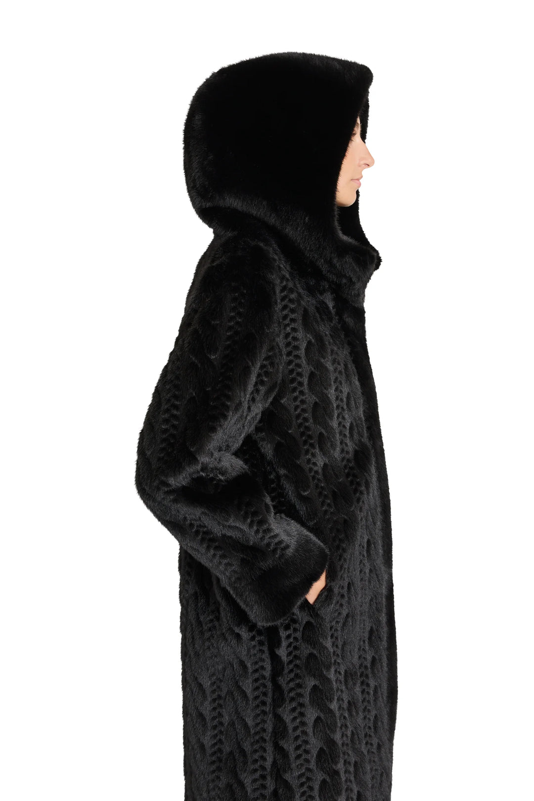 Textured black faux fur coat with cable pattern, hooded, straight silhouette. Side view on model.