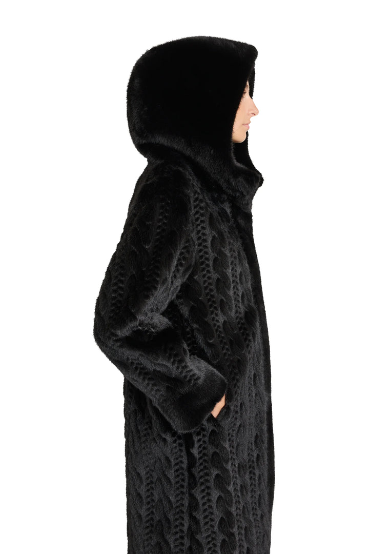 Textured black faux fur coat with cable pattern, hooded, straight silhouette. Side view on model.
