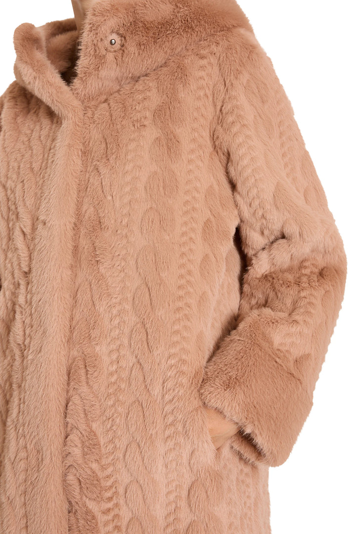 Faux fur coat with cable details, relaxed silhouette, side pockets. Front view on model.