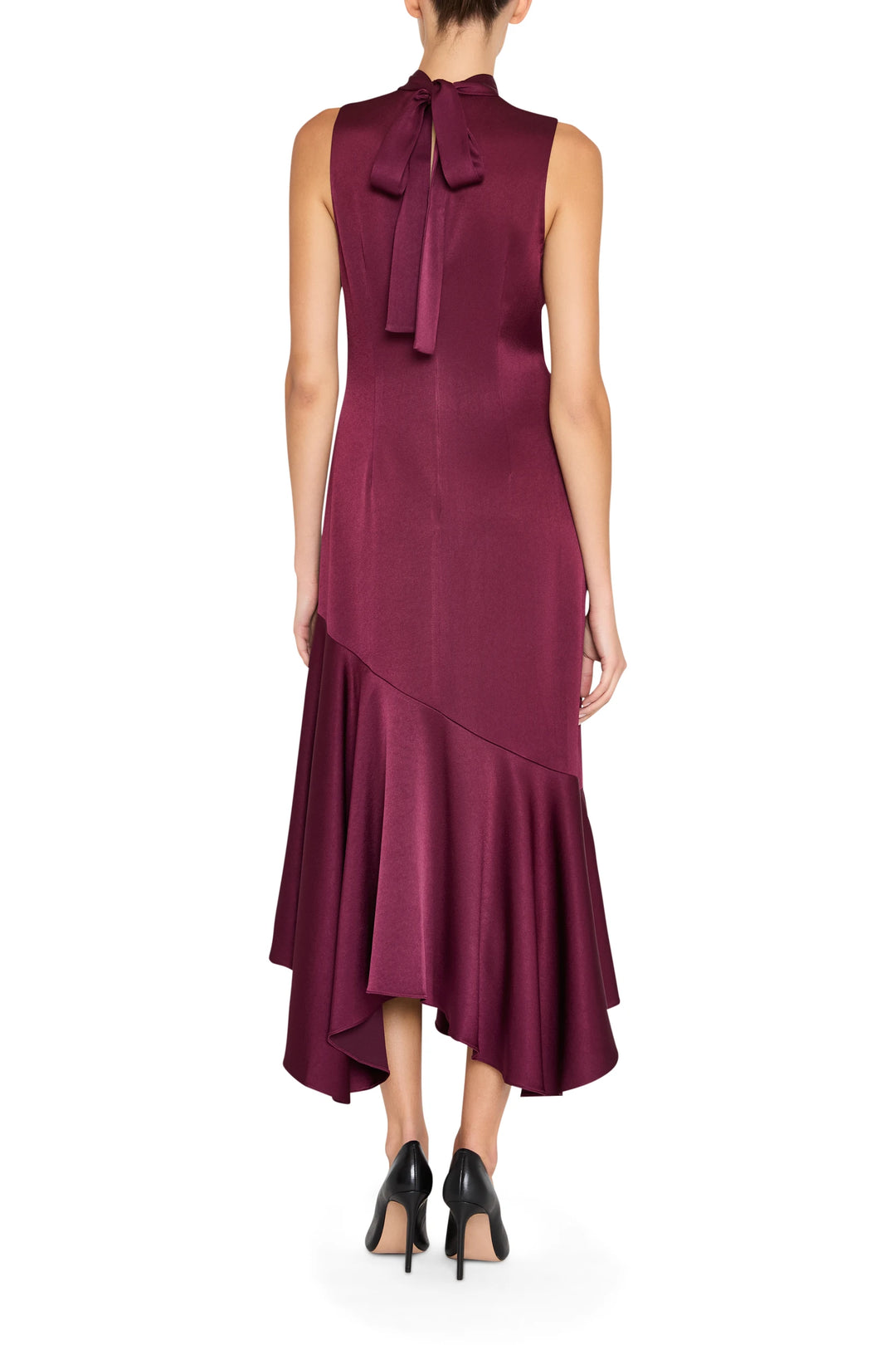Sleeveless crepe dress with asymmetrical hem and neck bow, fluid silhouette; back view on model.