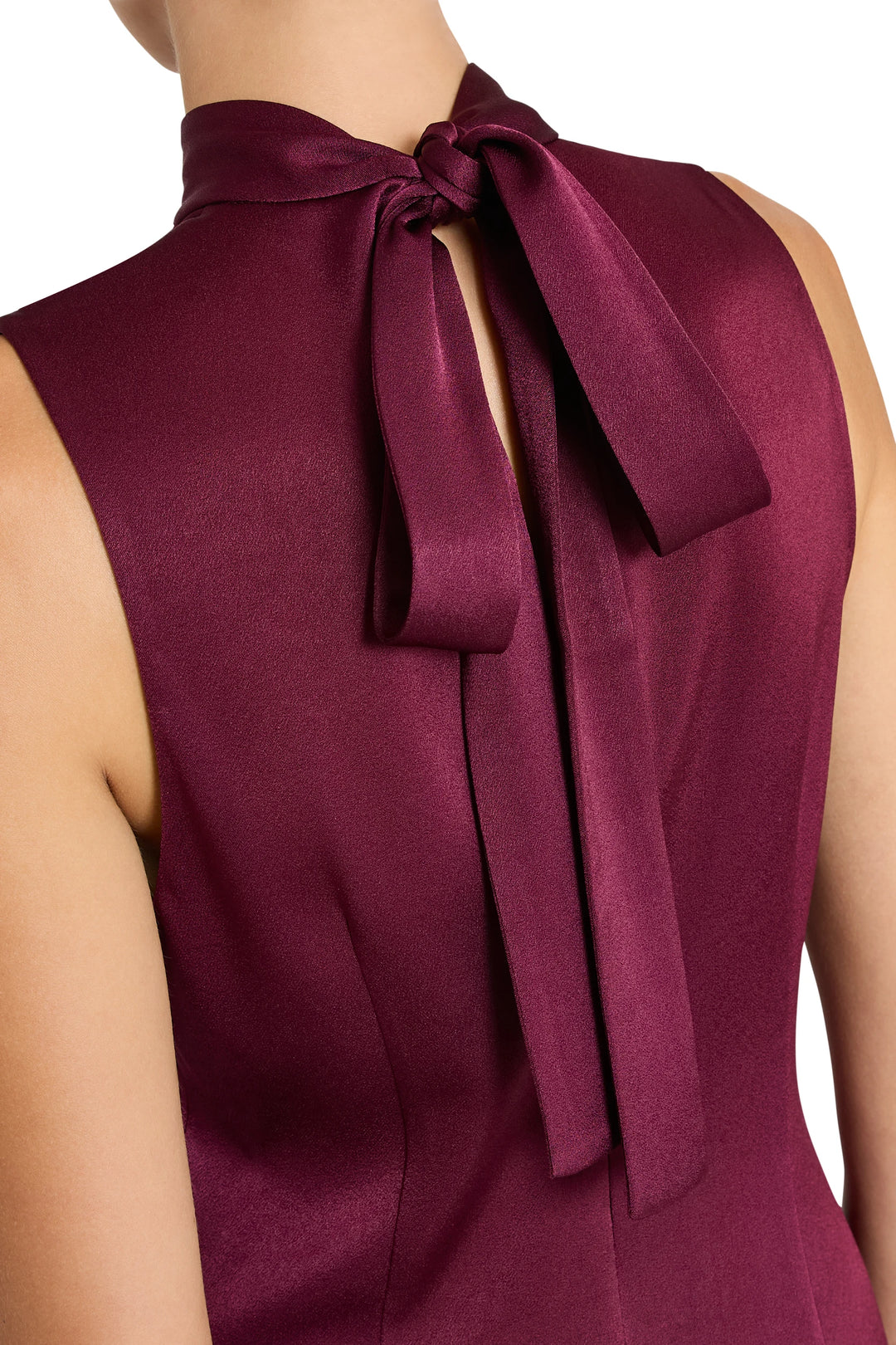 Sleeveless, fluid satin back crepe dress with neck bow, asymmetrical hemline; front view on model.