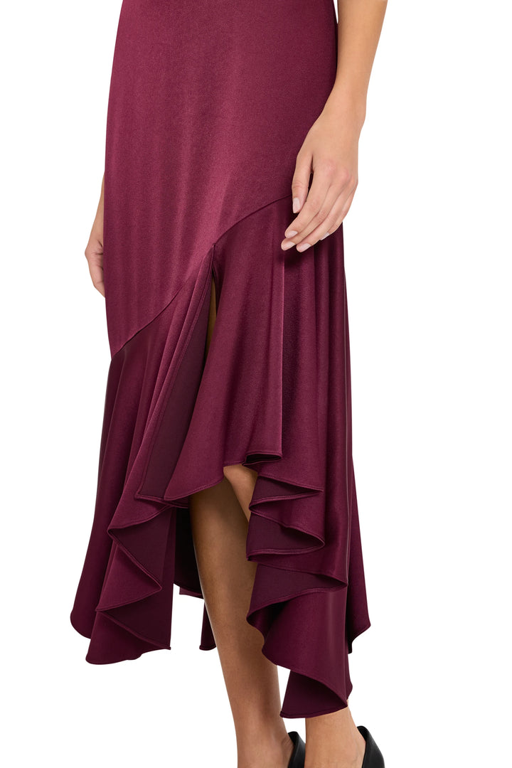 Burgundy crepe midi dress with asymmetric ruffled hem, fitted bodice; front view on white.