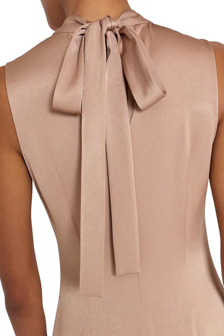 Large neck bow and fluid midi silhouette in satin back crepe. Detail of bow construction, detail view.