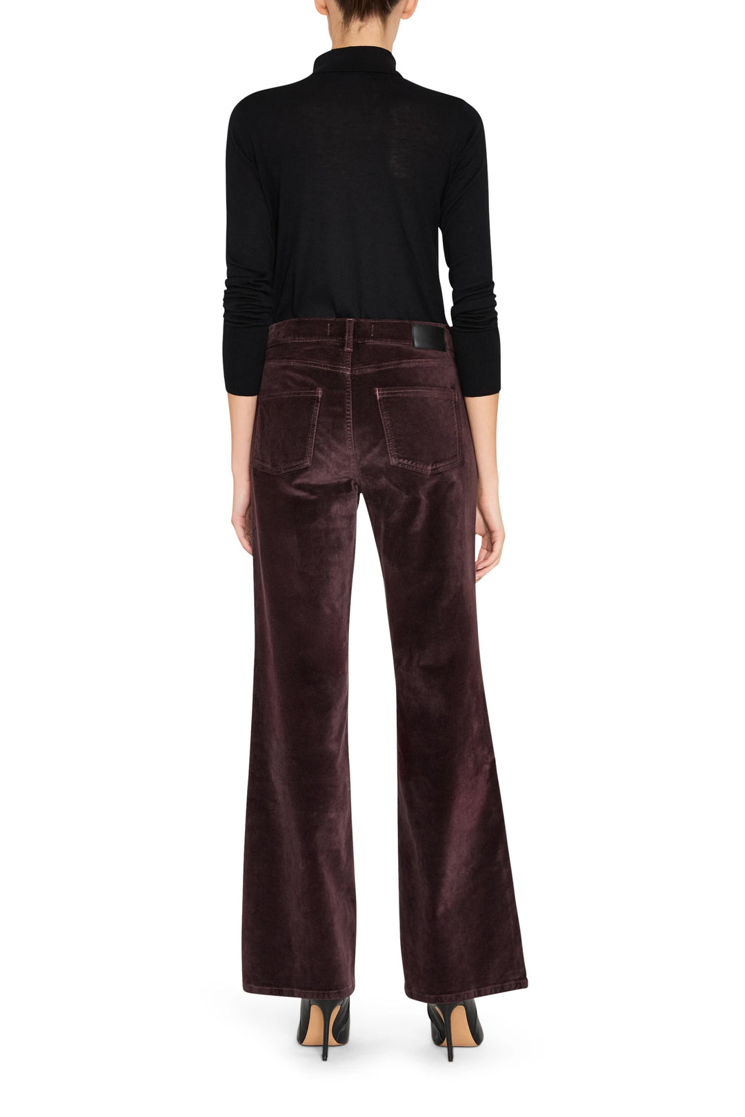 Wide-leg velvet pant with clean waistband and tailored seams, fluid drape; back view on model.