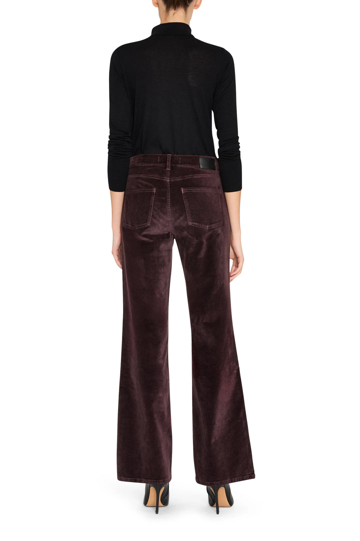 Wide-leg velvet pant with clean waistband and tailored seams, fluid drape; back view on model.