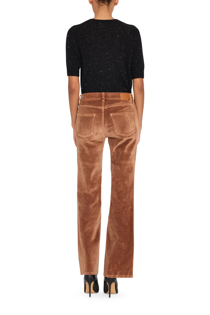 Mid-rise stretch velvet pant with wide-leg silhouette and smooth finish, front view on model.