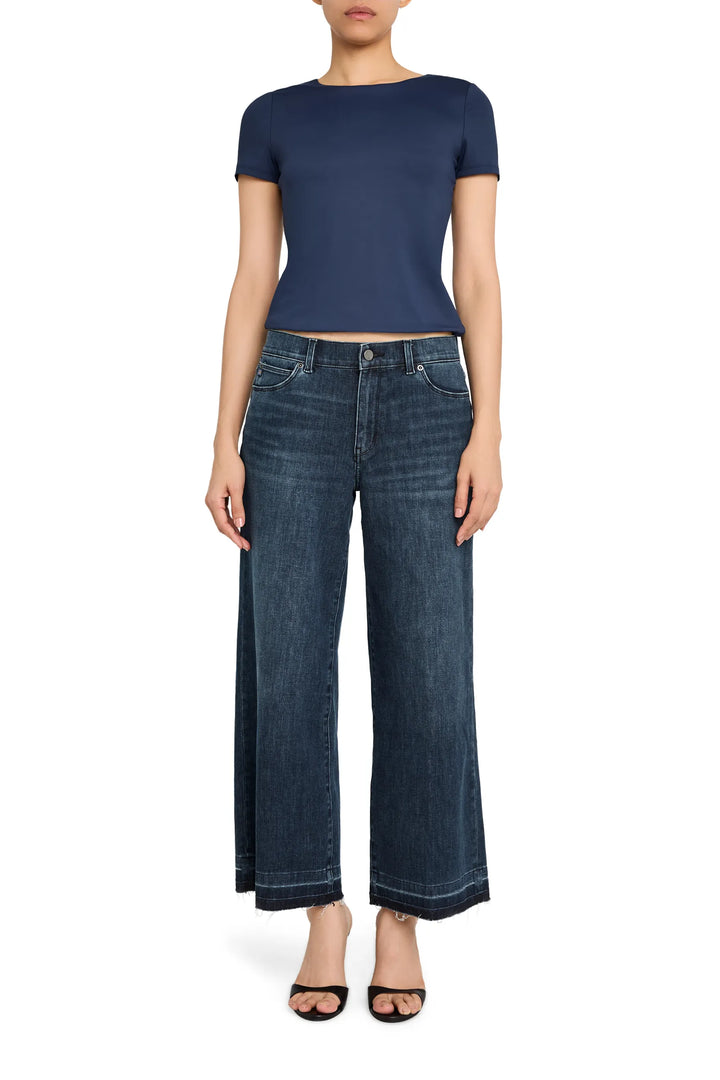 Cropped flare jean with raw-edge hem, fitted through hip, wide-leg silhouette, front view on model.