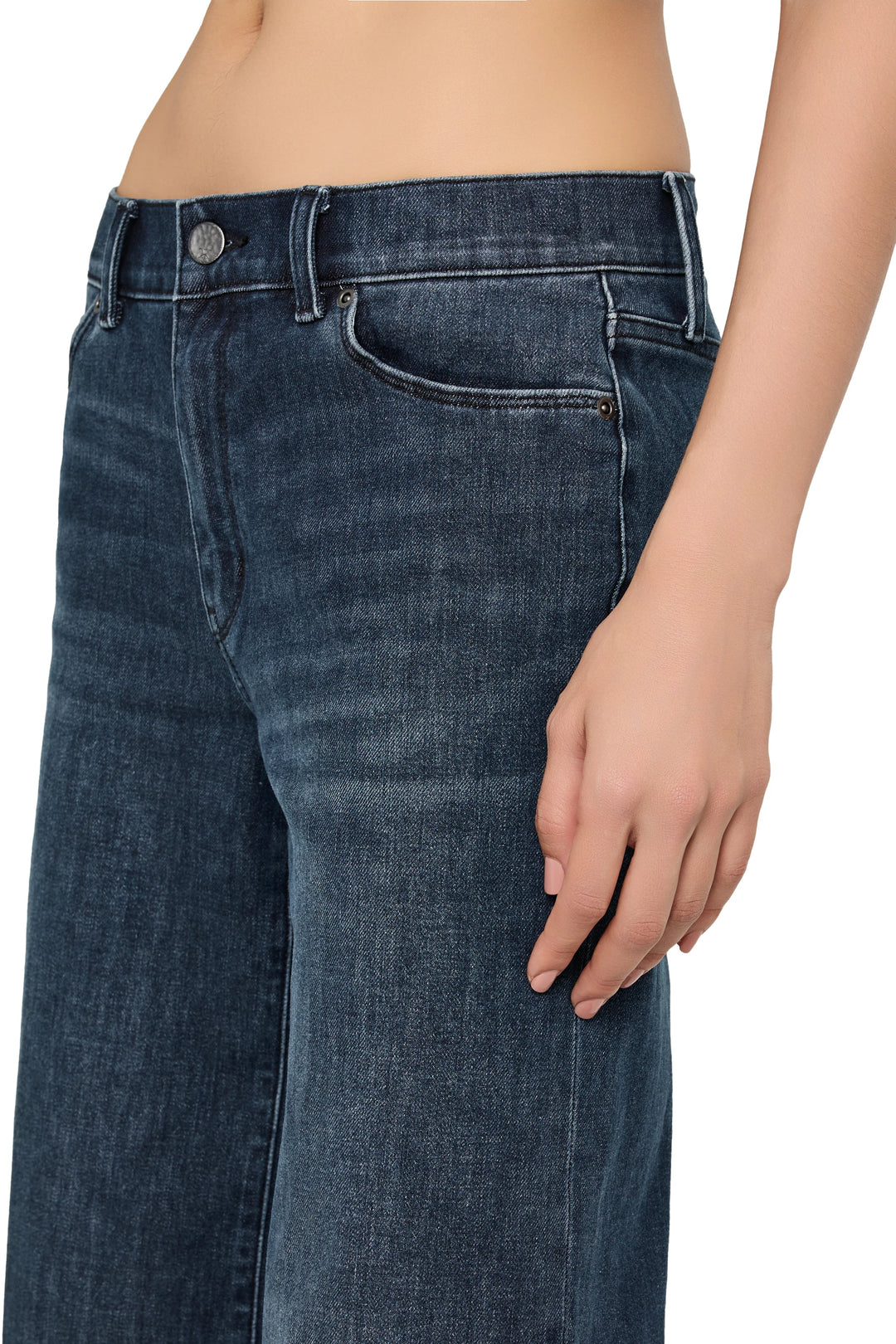 Cropped flare silhouette jeans with raw-edge hem, structured denim construction, front view on model.
