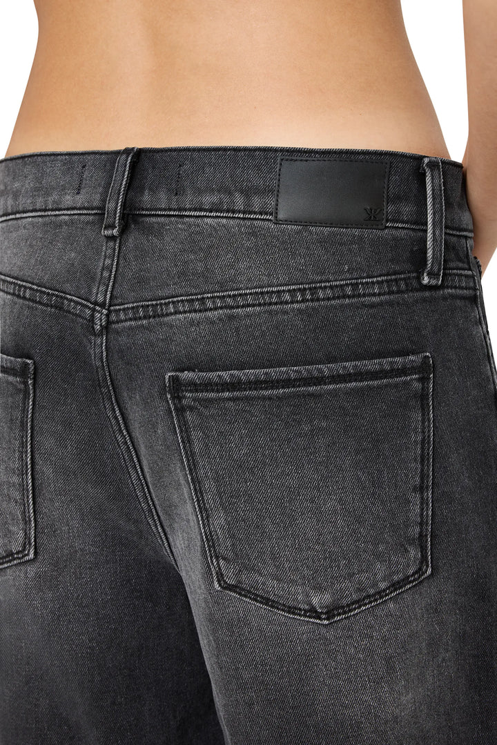 Cropped flare jean with raw-edge hem, fitted waistband, visible brand patch, denim construction; back view on model.