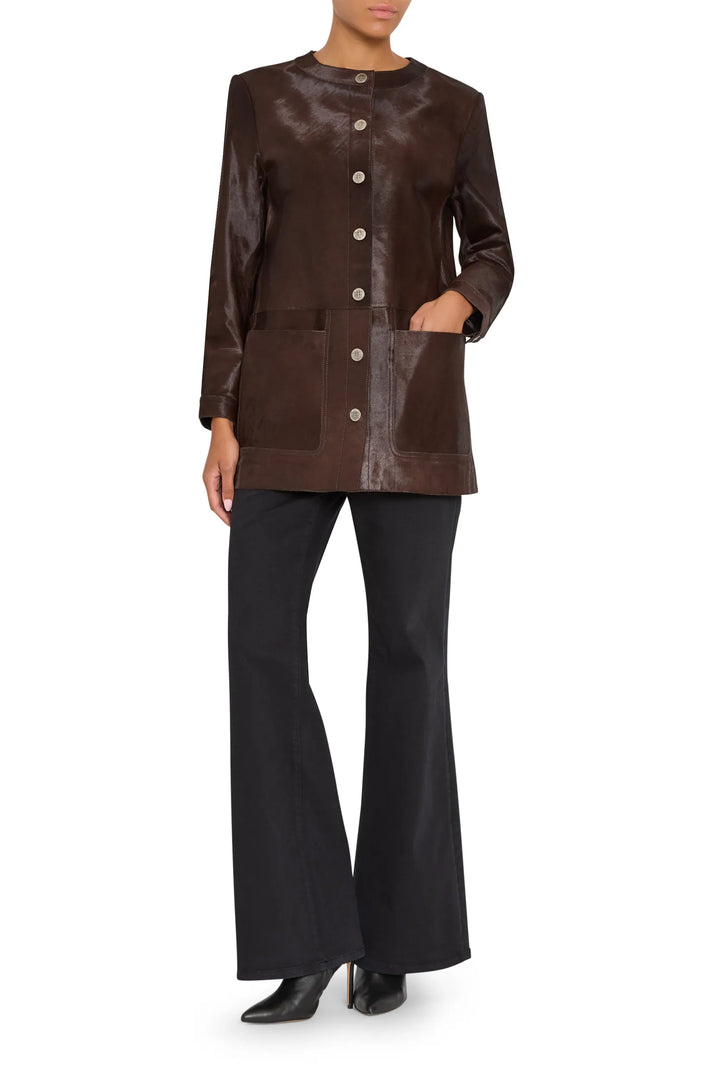 Longline silhouette coat with pony-effect finish, structured shoulders, concealed closure. Front view on white.