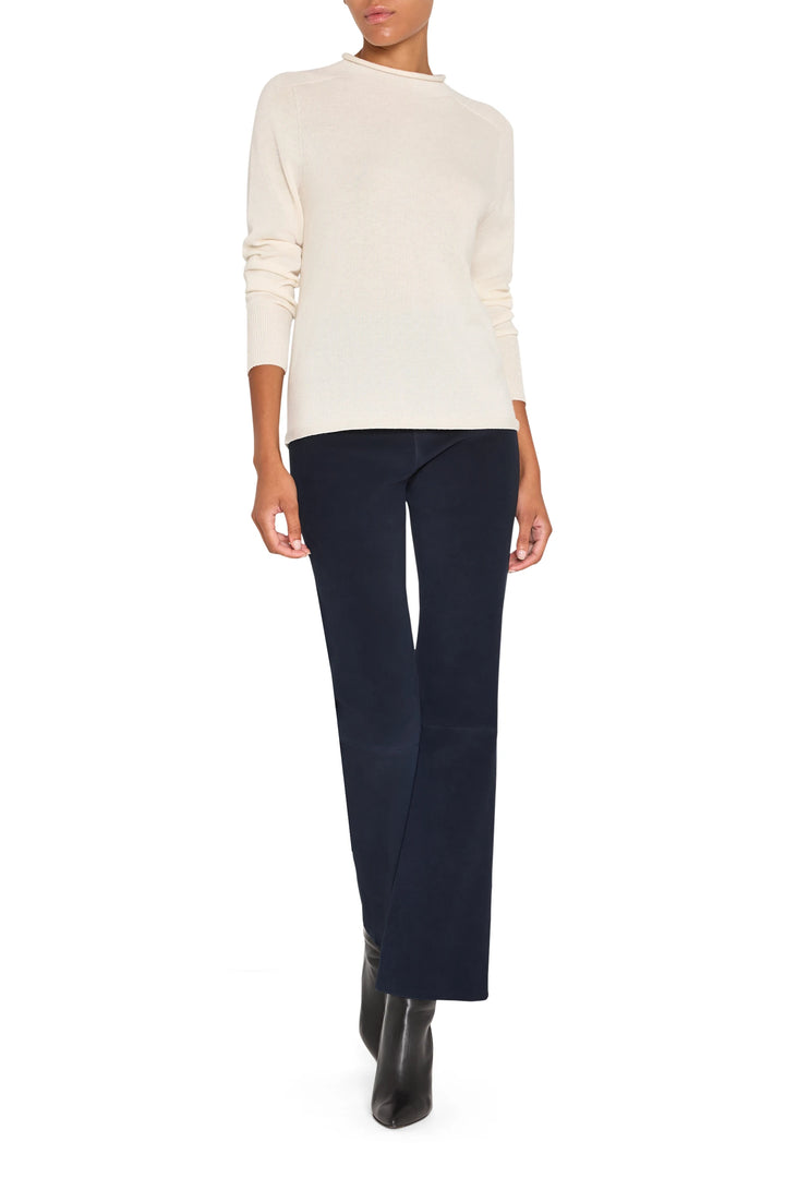 Seamless knit sweater with mock neck, long sleeves, classic fit and minimal detailing; front view on white.