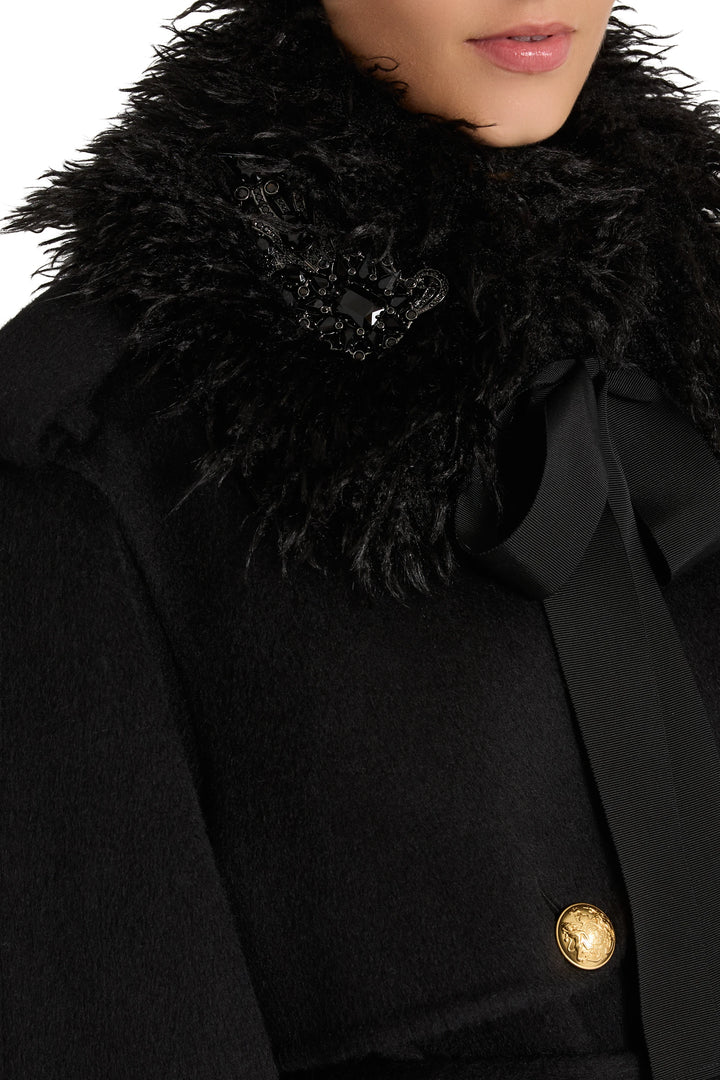 Embellished faux fur collar with black ribbon and gold button, detailed construction. Detail view.