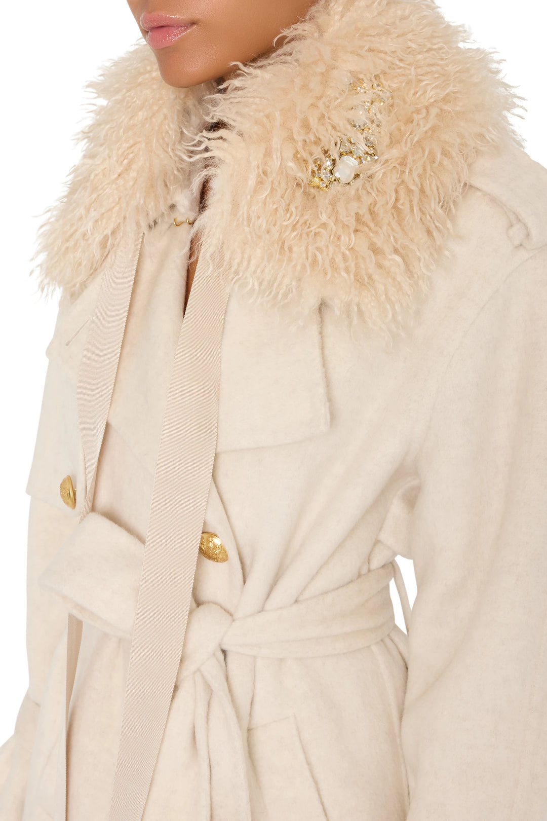 Tailored coat with faux fur collar, gold buttons, brooch accents; fitted bodice and flared hem. Front view on model.