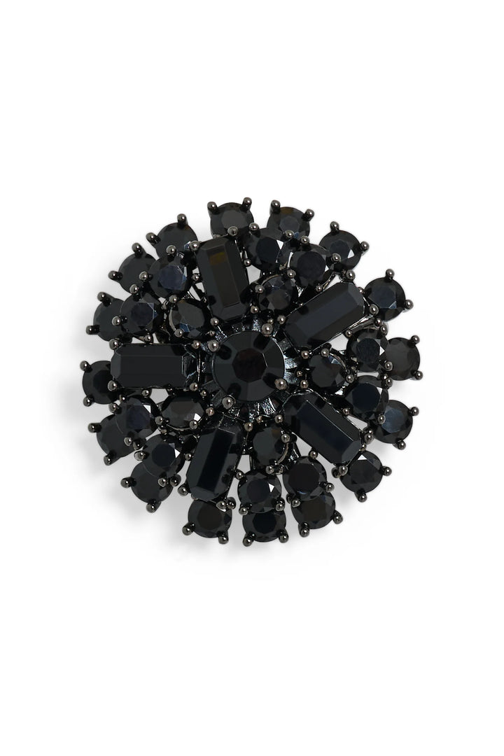 Brooch with clustered crystals set on dark metal, featuring intricate embellishment; front view on white.