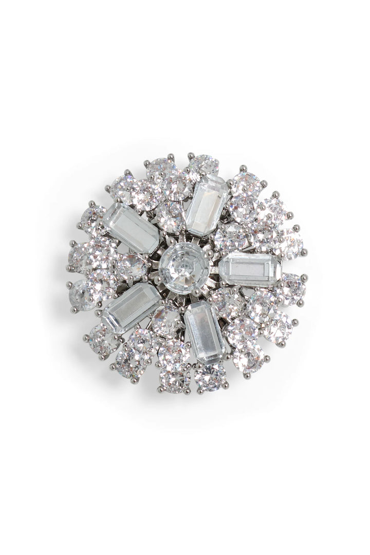 Round silver brooch with large center gem, clear crystal accents; detailed metalwork, front view on white.