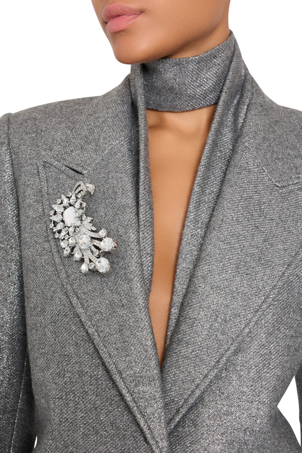 Crystal Claude Brooch, round-cut stones in sculpted setting; structured form, front view on model.