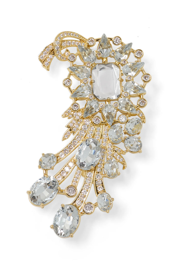 Gold brooch with sculptural silhouette, cascading design, intricate clear gemstone embellishment. Front view on white.