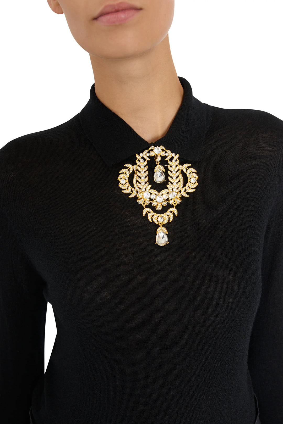 Jasmin Brooch with gold and suspended crystal accents, detailed embellishment. Front view on white.