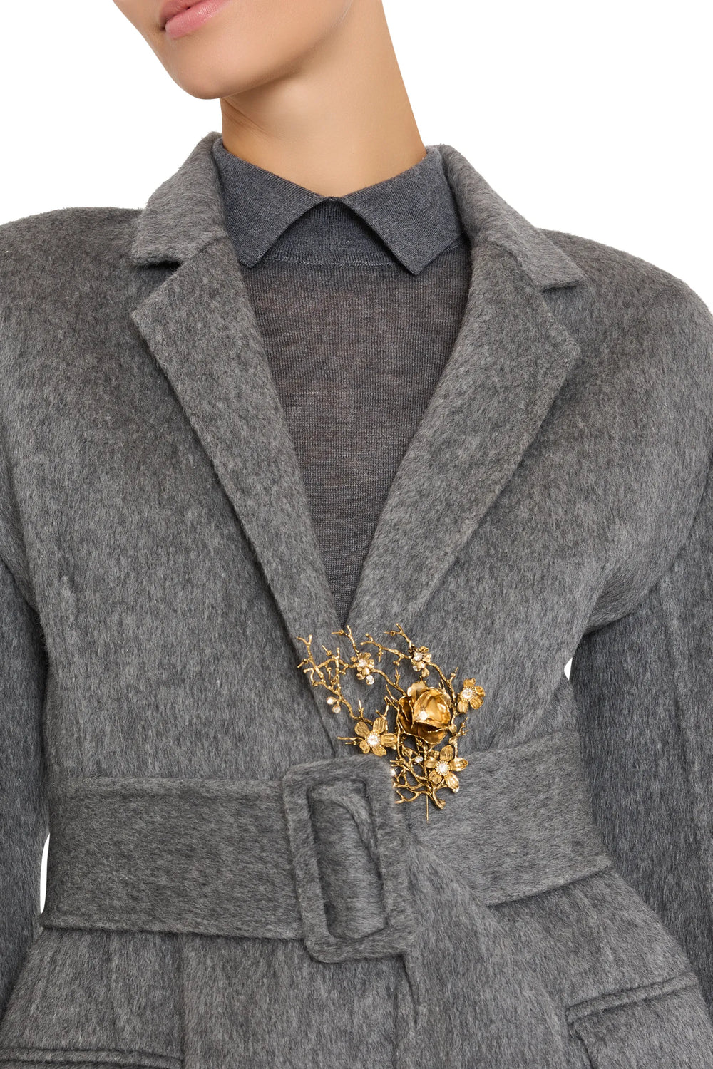 Belted midi coat with notched collar, structured silhouette, Sola Pin brooch; front view on model.