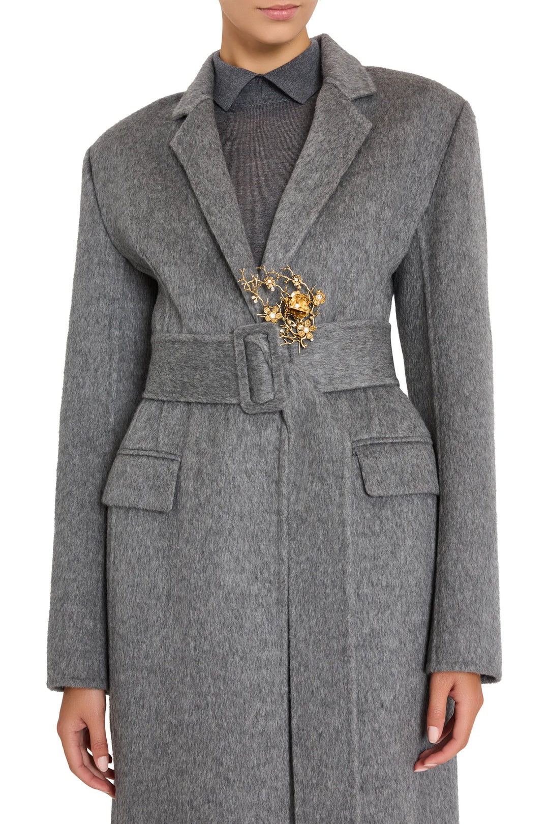 Sola Pin brooch with sculptural silhouette and minimalist construction, shown front view on model.