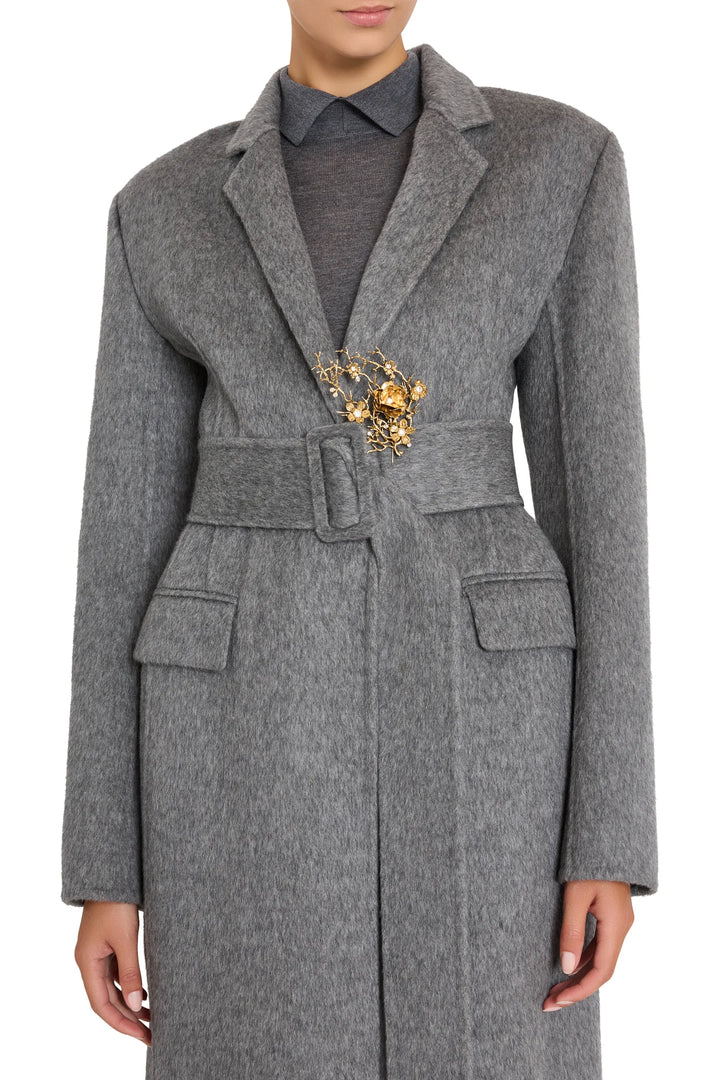 Sola Pin brooch with sculptural silhouette and minimalist construction, shown front view on model.